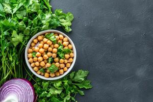 Chickpeas, parsley, red onion on dark background, healthy food photo