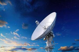 Satellite dish under starry night sky at sunset for space communication photo