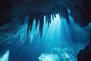 Sunbeams illuminate stalactites in underwater cave photo