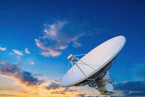 Satellite dish at sunset with stars, for telecommunications photo