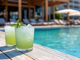 Two mint cocktails by pool at resort photo