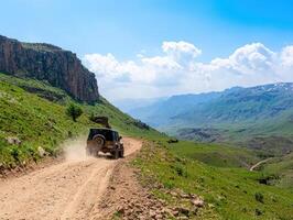 4x4 vehicle on dusty mountain road, scenic valley view, adventure travel photo