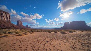 Monument Valley sunny desert landscape with buttes and clouds photo