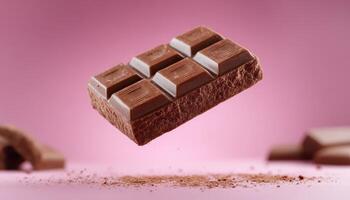 Milk chocolate on pink background photo
