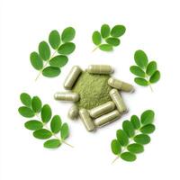 Top view Finely organic dried Moringa powder in capsules isolated on white background photo