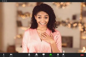 Virtual Meeting, Social Distancing, Isolation. Surprised happy black woman making online call on laptop, holding hand on chest, talking with partner, monitor view with app software for videotelephony photo