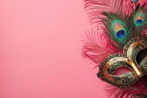 A carnival mask and peacock feathers on a pink background photo