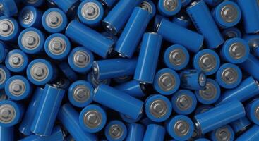 Pile of blue cylindrical batteries from an overhead view, symbolizing energy and power. photo