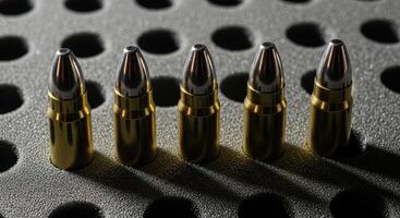 Shiny golden bullets for firearms standing upright in a protective case. photo