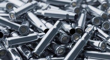 Pile of metallic spent bullet casings scattered in a heap, close up view photo