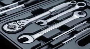 A professional metal tool kit with wrenches, ratchet, and screwdrivers for repair and maintenance. photo
