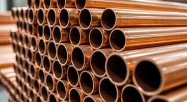 Stack of shiny copper pipes for industrial, construction, and plumbing applications photo