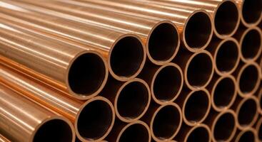 Stacked shiny copper pipes for industrial use in construction and plumbing photo