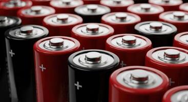 Close up view of red and black aa batteries arranged in rows, symbolizing power and energy. photo