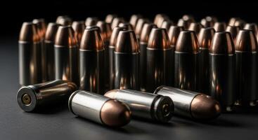 Close up view of 9mm handgun bullets cartridges arranged on a dark background photo