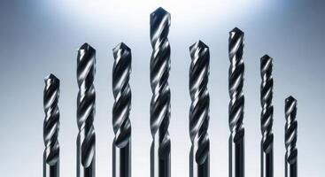 Set of shiny metal drill bits of various sizes for industrial and construction work photo