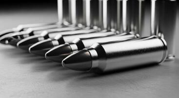 Close up view of metallic bullets and ammunition cartridges arranged on a dark surface photo