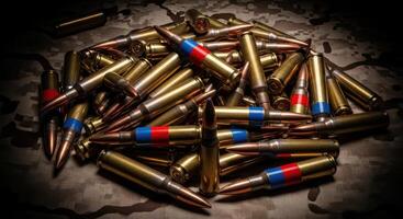 Pile of rifle bullets and ammunition cartridges on a military camouflage background photo
