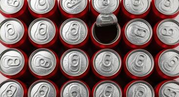 Top view of red soda cans with one open, showing cold refreshing beverages and condensation photo