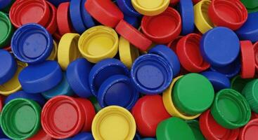 Colorful plastic bottle caps in a pile, highlighting recycling and environmental issues photo