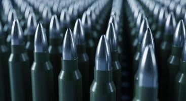 Rows of military rifle bullets with metallic tips and green casings, close up view photo