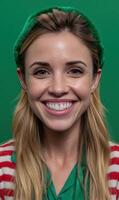 Smiling woman in festive attire against green backdrop photo