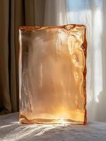 Abstract amber glass slab illuminated by sunlight photo