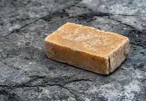 Rustic bar of handmade soap on a textured surface photo