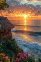 A beautiful beachfront bungalow enjoys a stunning ocean sunset view photo
