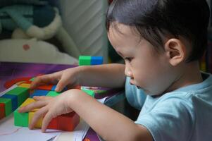 Focused Child Playing with Blocks photo