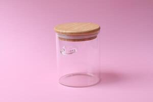 empty glass jar with lid on pink background for food use. Side view photo