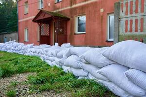Sandbags stacked near house to protect from flooding photo