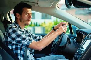 Man looking at rear view in modern car photo