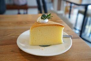 Close up dish of butter cake with whipped cream photo