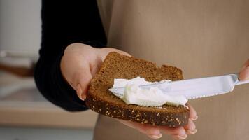 A chef holds a slice of healthy whole grain bread in a well-equipped kitchen. The setting emphasizes nutrition and eco-friendly cooking practices for a wholesome lifestyle. video