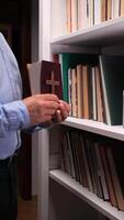 A man holding a book in front of a shelf of books video