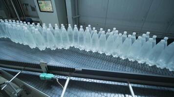 Water bottles aligned for automated capping video