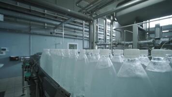 Rows of clear bottles on automated track video