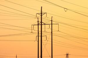 Electricity Pylons Standing Tall Against a Bright Sky photo