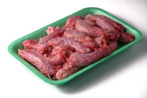 Raw Chicken Necks Packaged for Sale on White Background photo