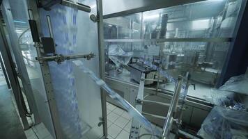 Automated bottling system operating in sterile manufacturing room. video