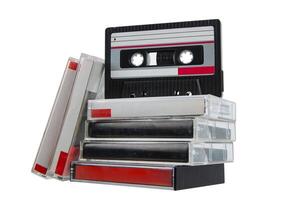 Retro audio cassette and stack of cases with red labels isolated on white back photo
