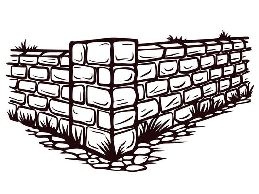 Corner of a stone wall with grass and rocks in a rustic setting