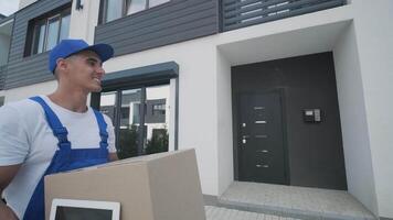 Smiling courier with package in uniform video