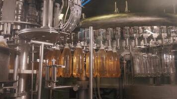 Conveyor with orange drink bottles video