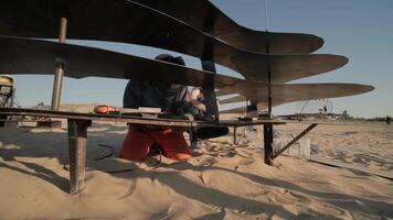 Side view of ground-level drone prototype with layered rotors on test bench. video