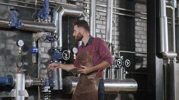 Brewer monitoring pressure and temperature in the fermentation system video