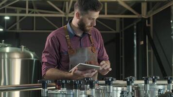 Brewer tasting and analyzing malt directly from hopper video