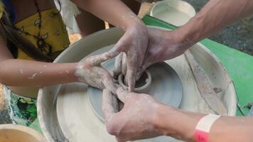 Collaborative Pottery Creation on Clay Wheel During Workshop video