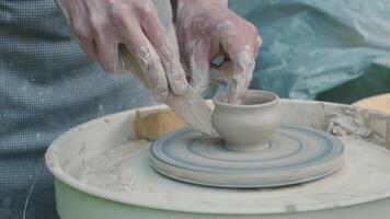 Close View of Potter Shaping Vessel with Hands on Spinning Wheel video